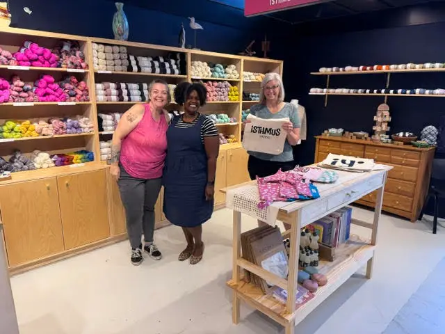 Isthmus Yarns shop interior with a customer browsing craft supplies