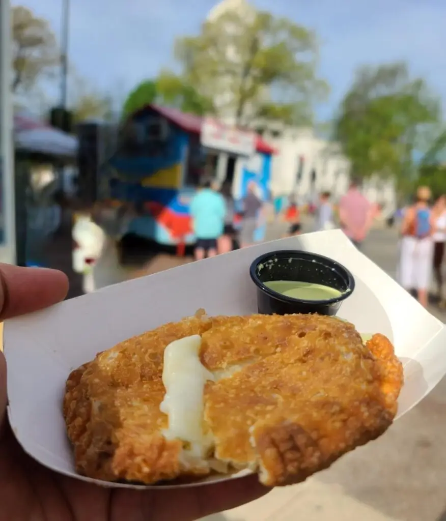 Empanada served on a plate with dipping sauce